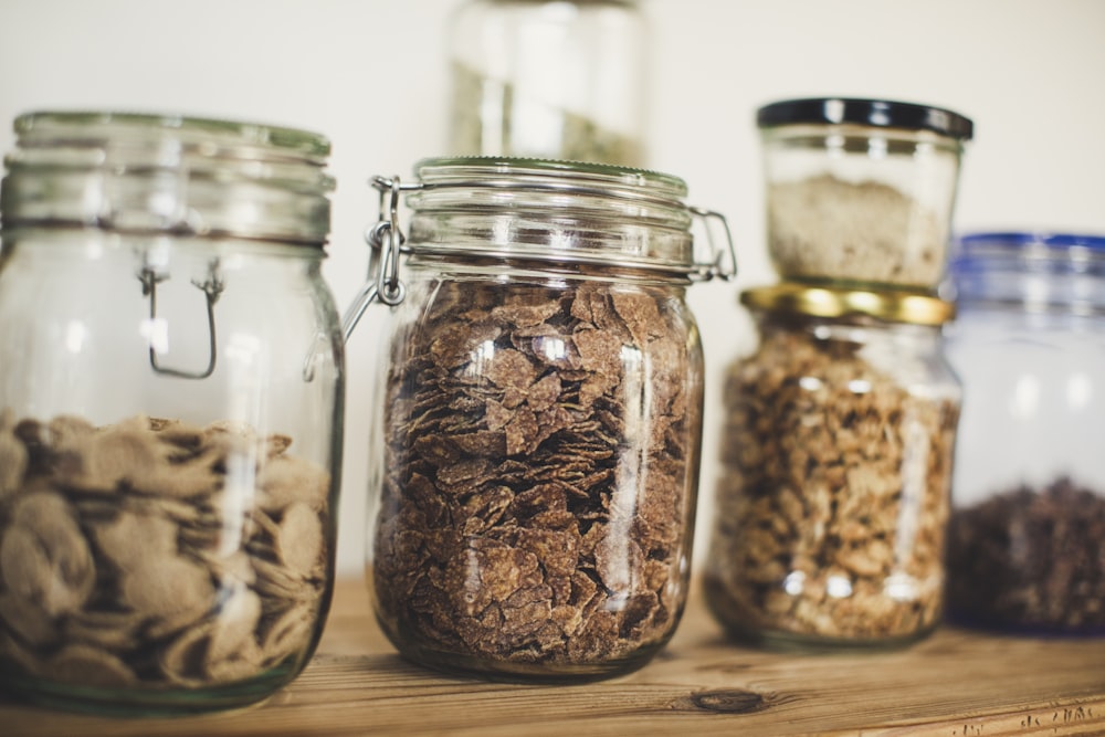 a group of jars filled with different types of food