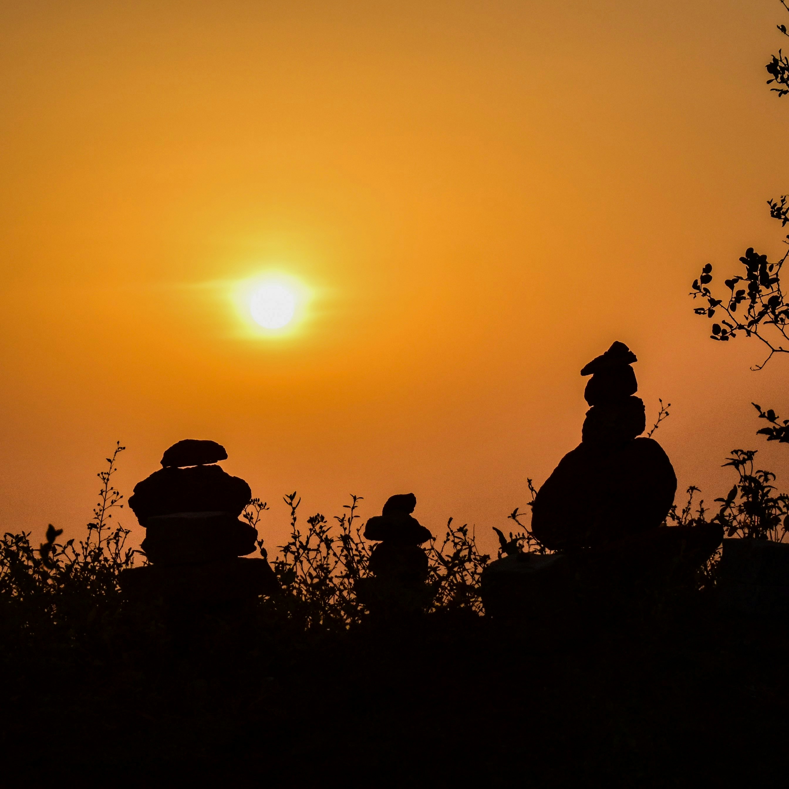 a group of people sitting on top of a hill
