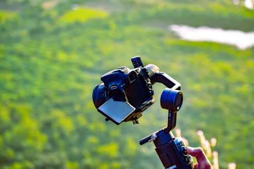 a person holding a camera up in the air