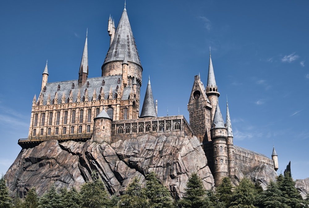 a castle on a hill with a blue sky in the background