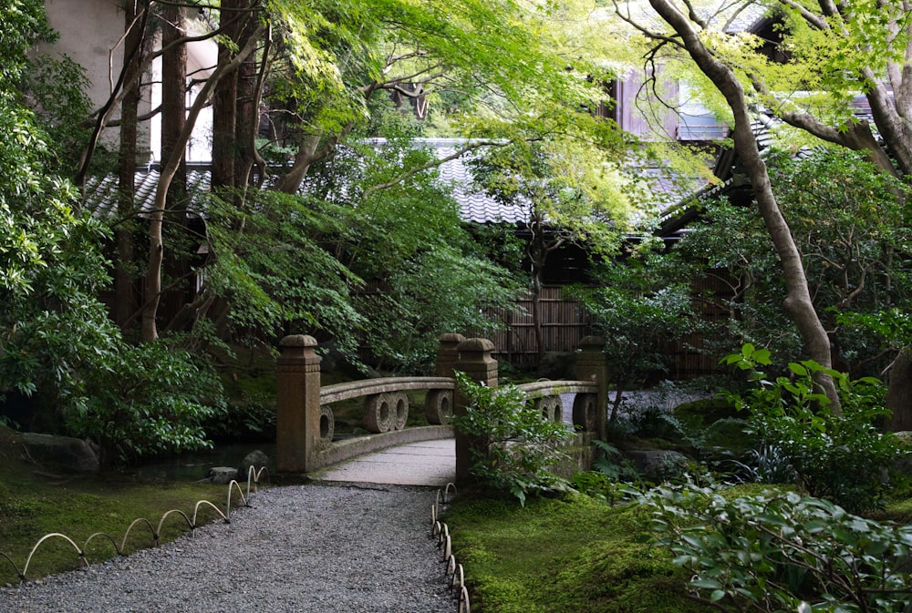 a stone bridge in a lush green garden