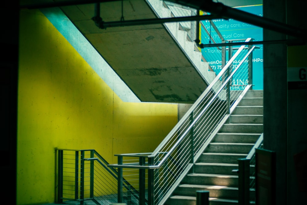 a stairway leading up to a yellow wall