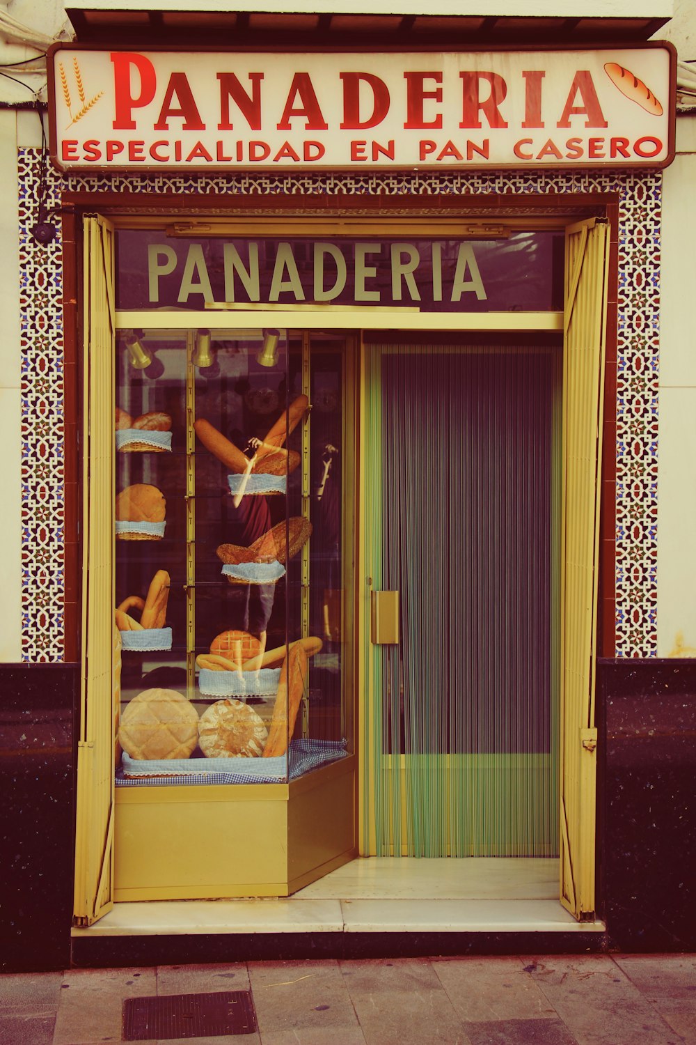 a store front with a display of baked goods
