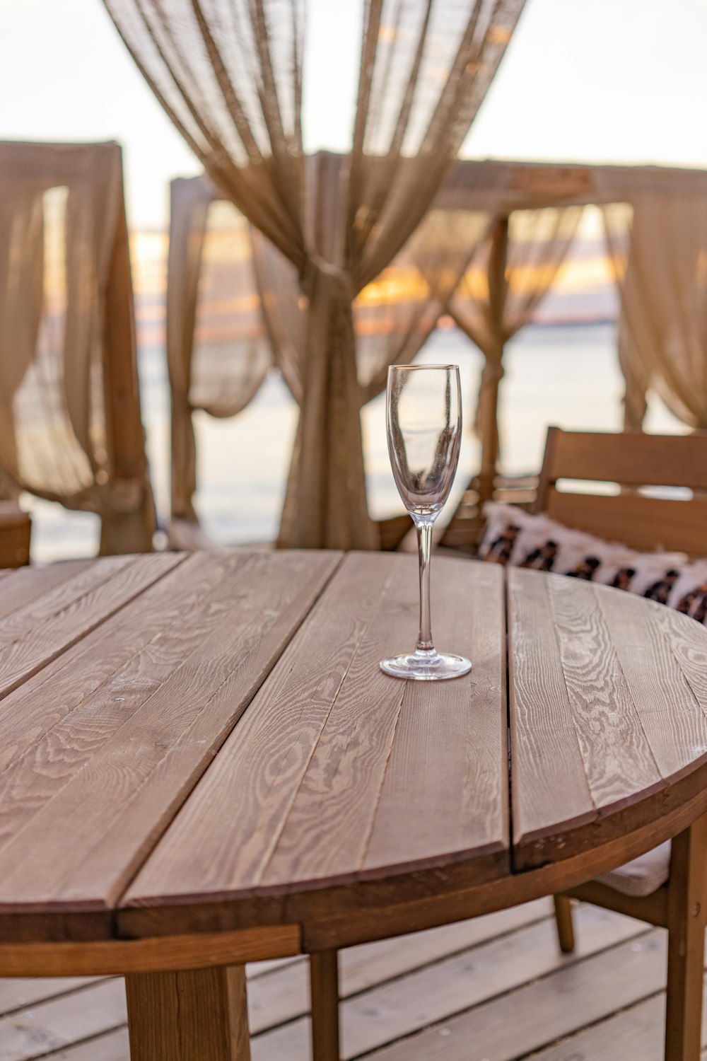 a wine glass sitting on top of a wooden table