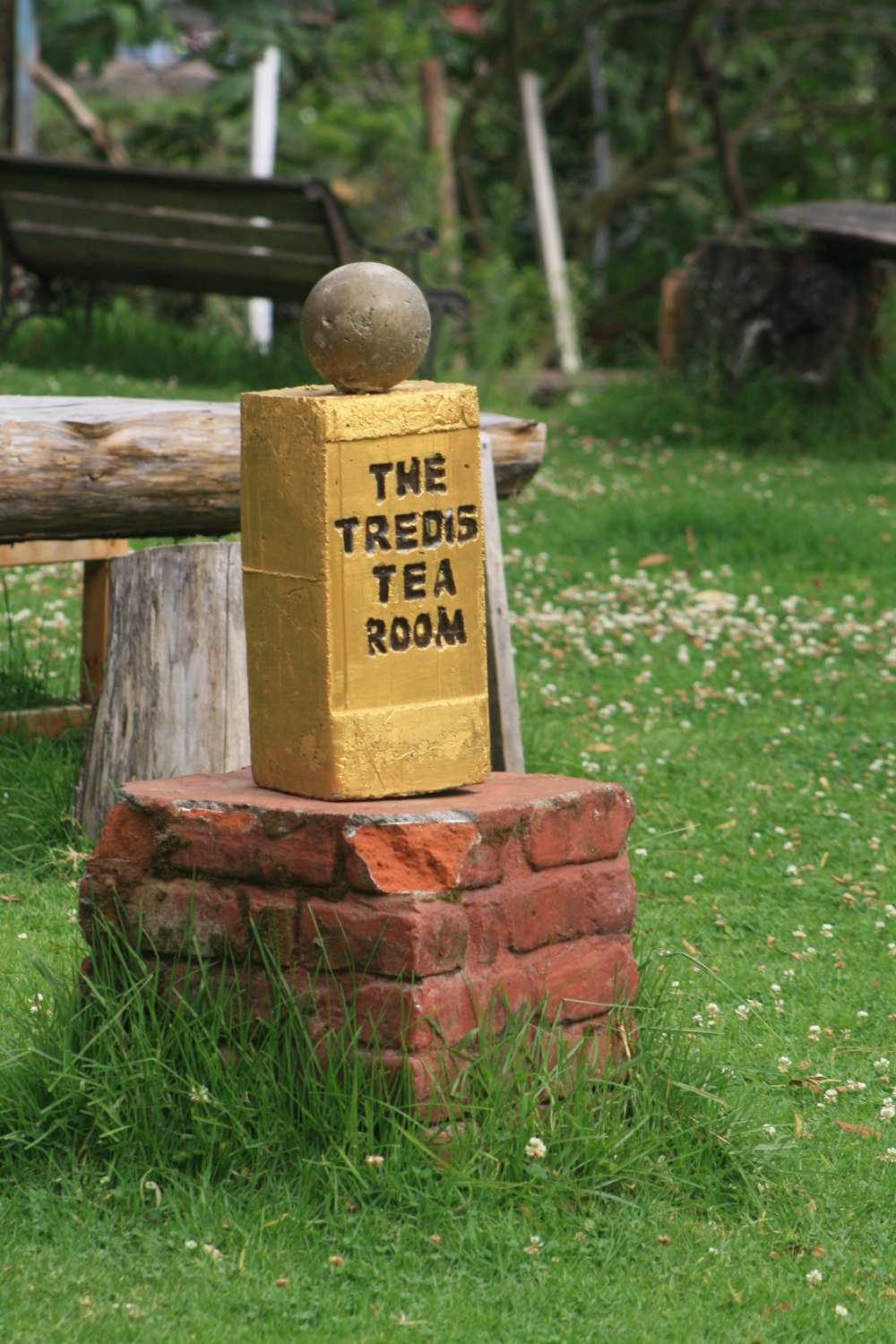 a yellow box sitting on top of a wooden bench