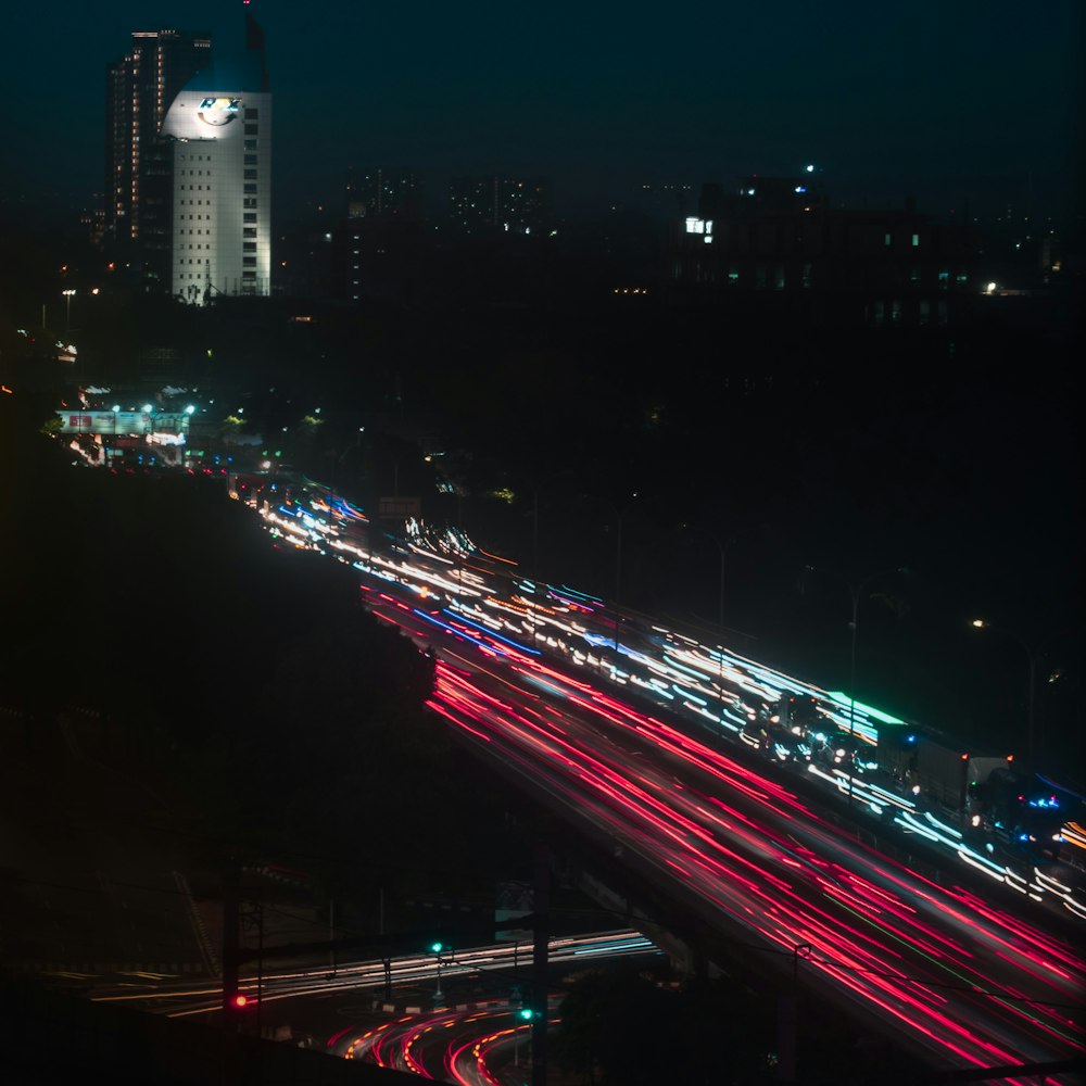 a city street filled with lots of traffic at night