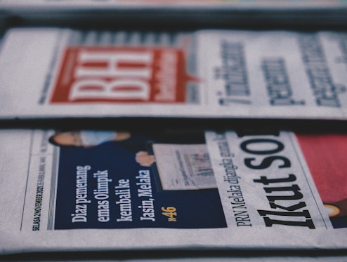 a row of newspapers sitting on top of a table