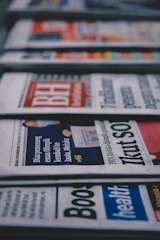 a row of newspapers sitting on top of a table
