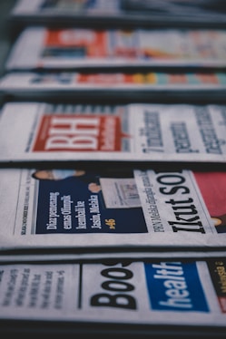 a row of newspapers sitting on top of a table