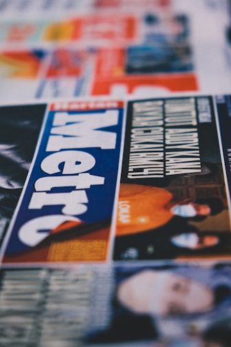 a close up of a newspaper with a picture of a man