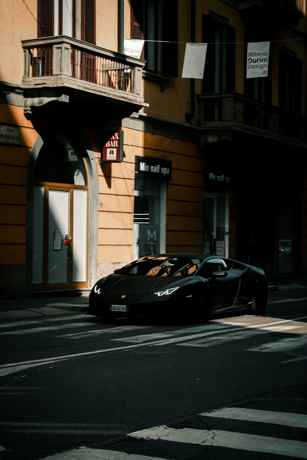 a black sports car parked on the side of the road