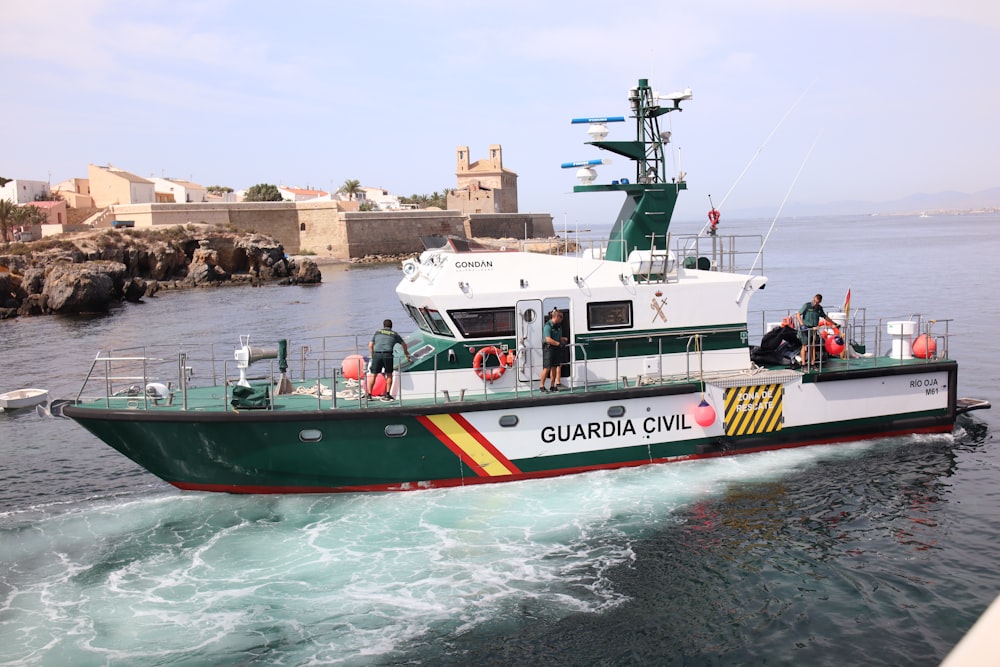 a large green and white boat in the water