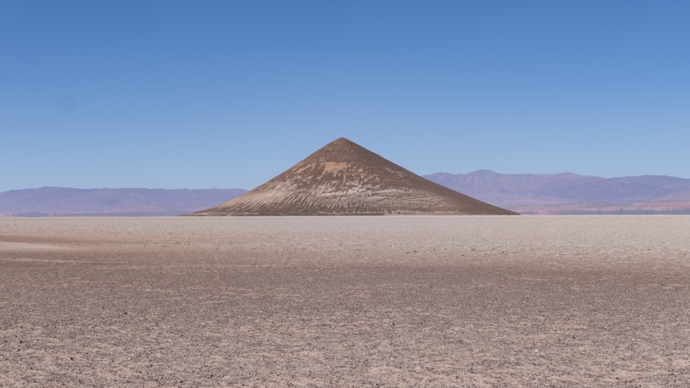 a lone mountain in the middle of a desert