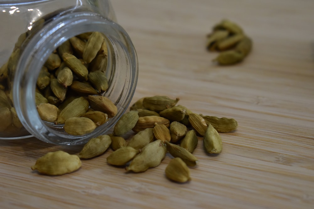 a glass jar filled with nuts on top of a wooden table