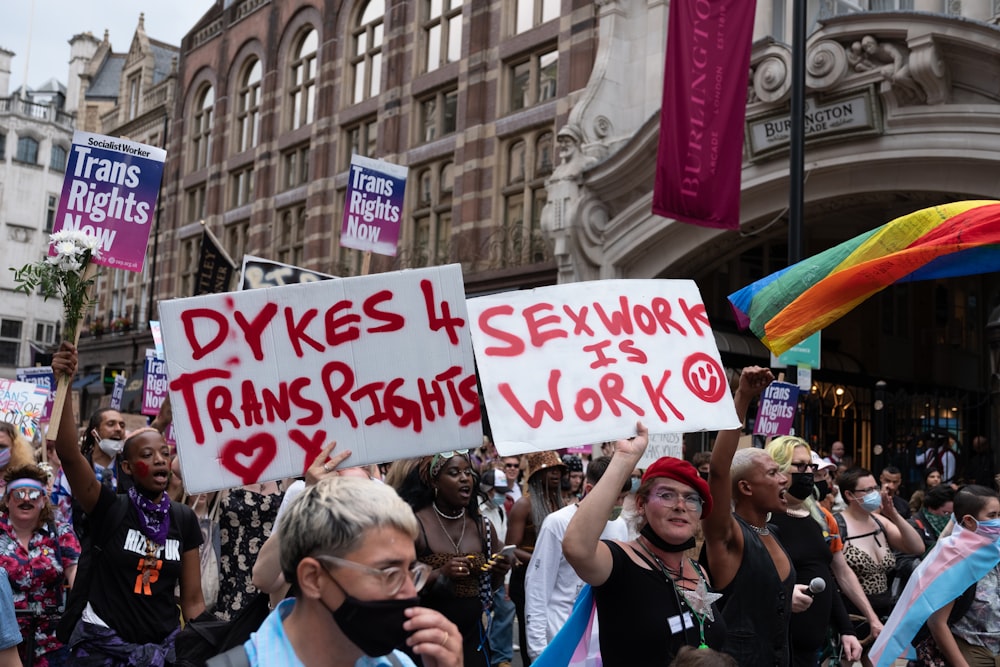 a group of people holding signs in the street