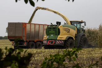 Agricultural machinery loading big bags in a vast Brazilian field.