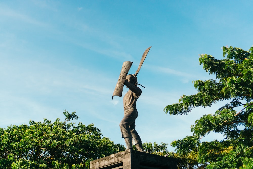 a statue of a man holding a large knife