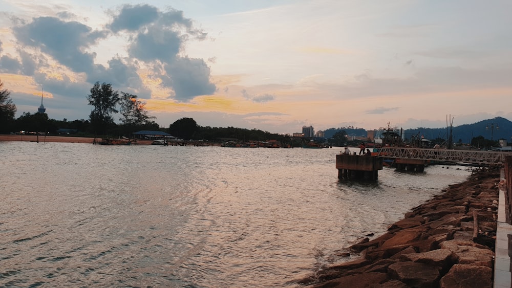 a body of water with a bridge in the background