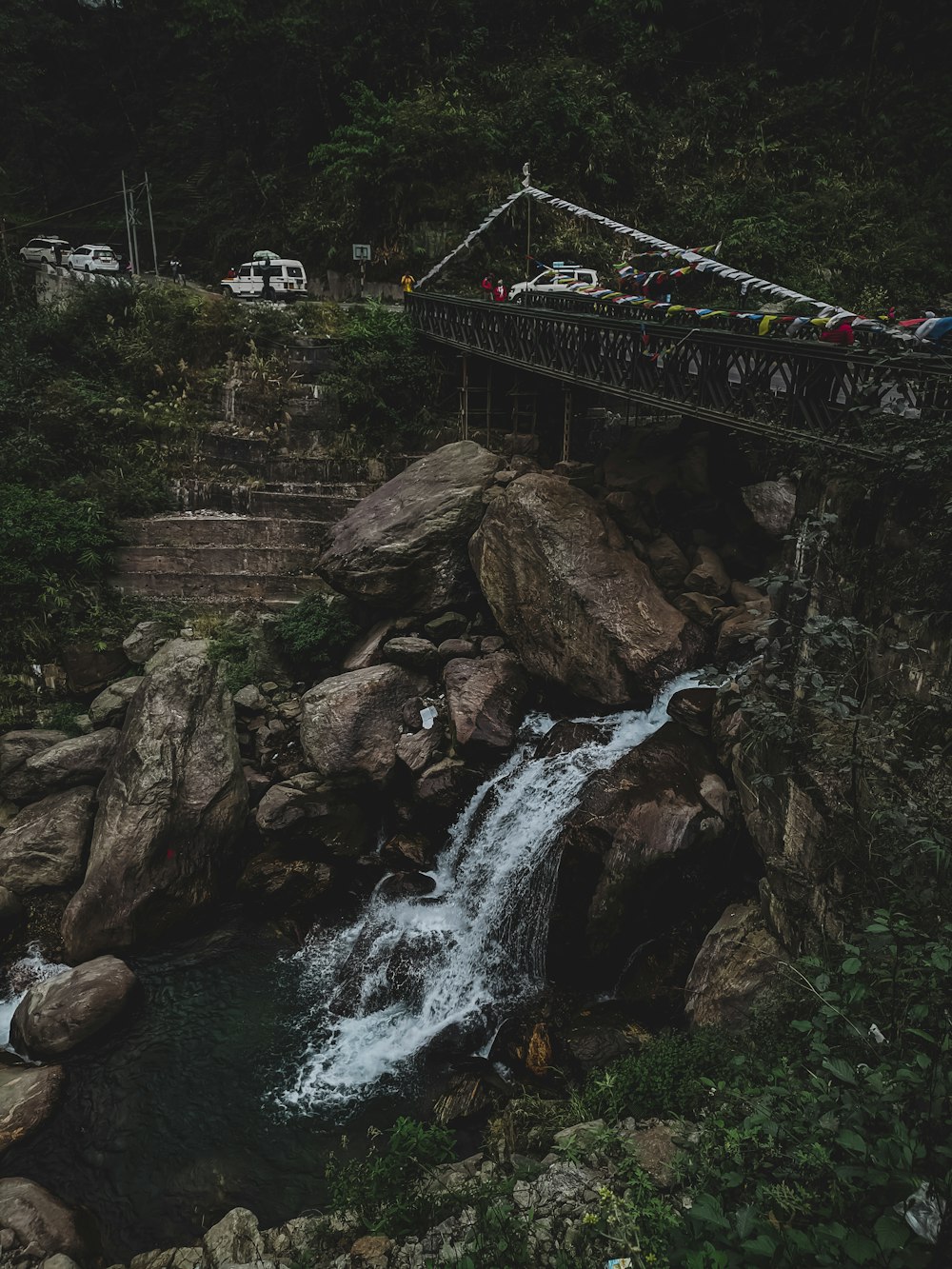 a bridge over a river with a waterfall
