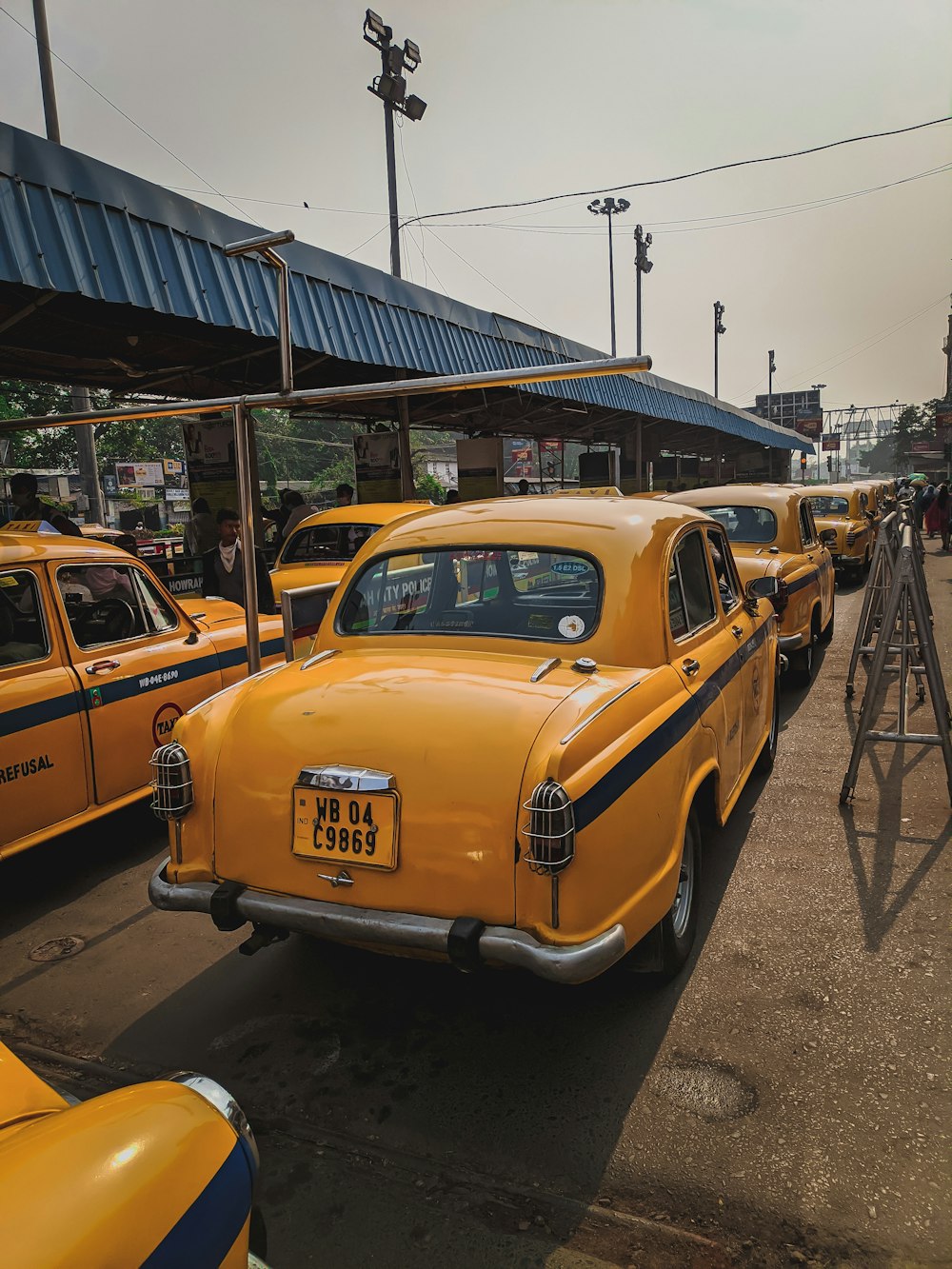 a row of yellow taxi cabs parked next to each other