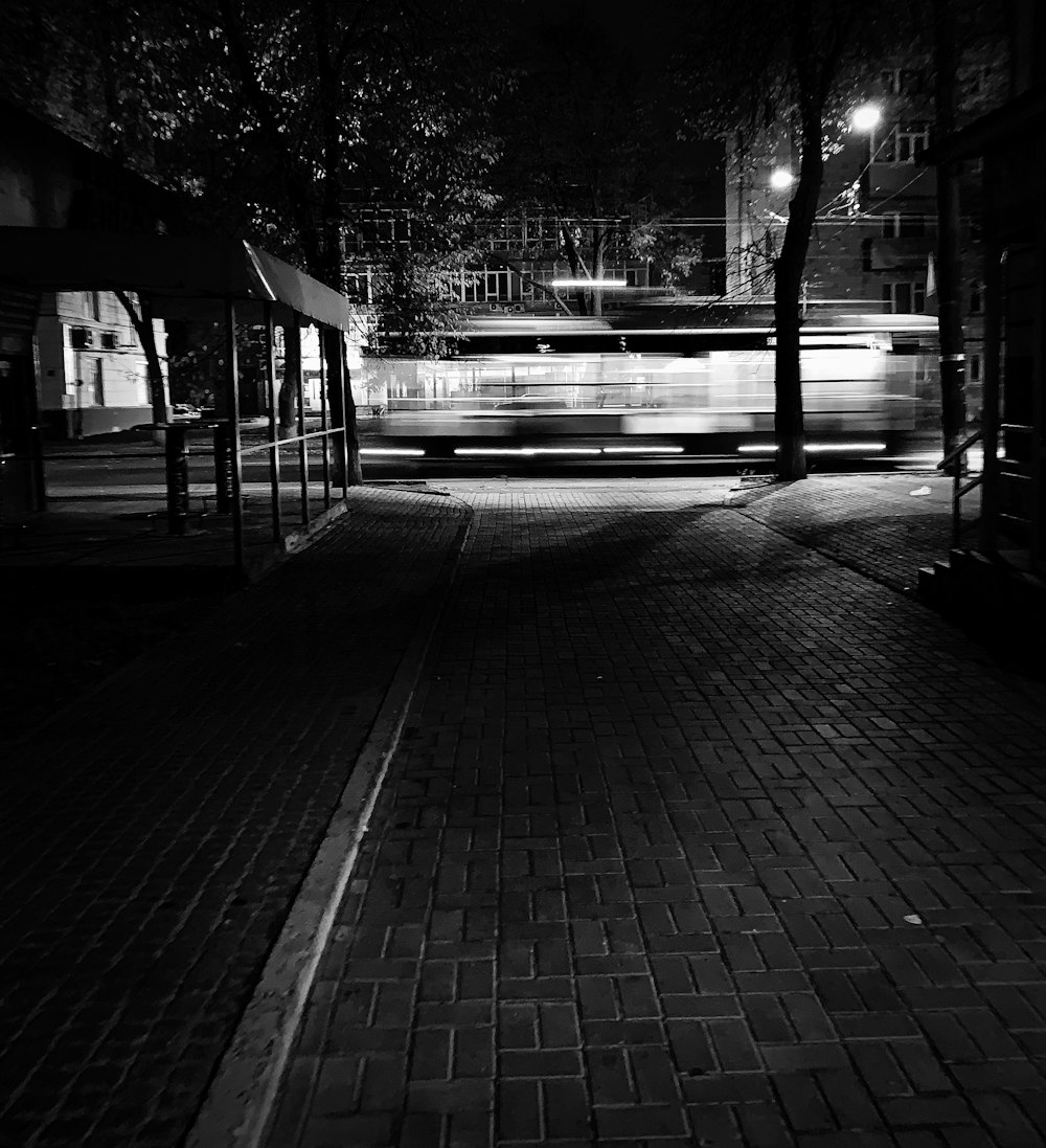 a black and white photo of a bus at night