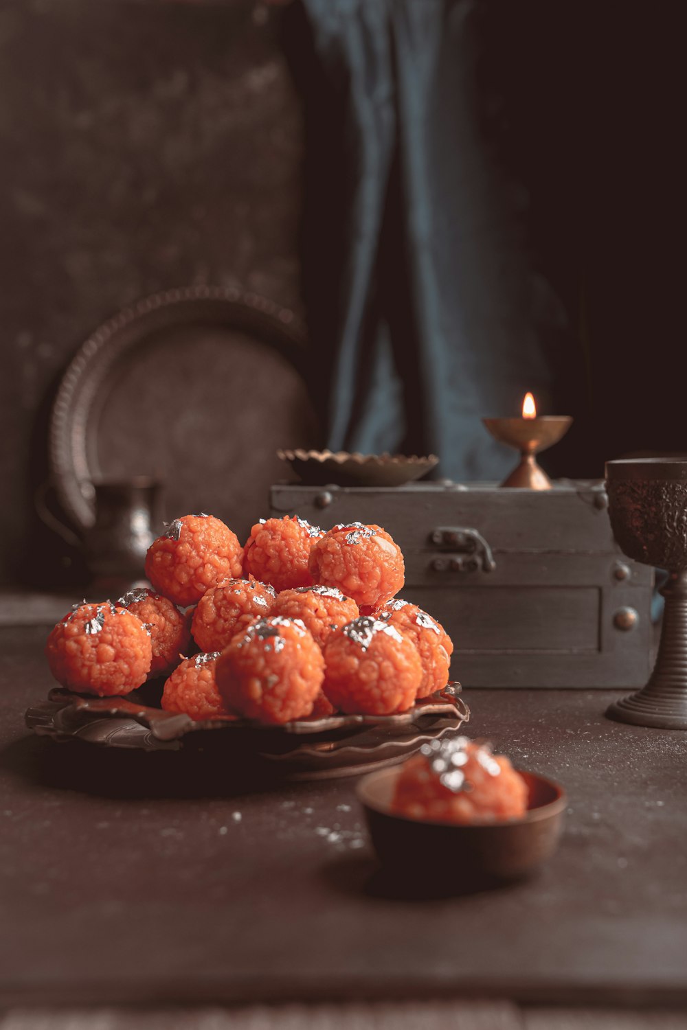 a plate of food sitting on a table next to a candle