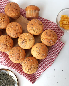 a bunch of muffins sitting on top of a red and white checkered