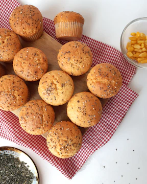 a bunch of muffins sitting on top of a red and white checkered