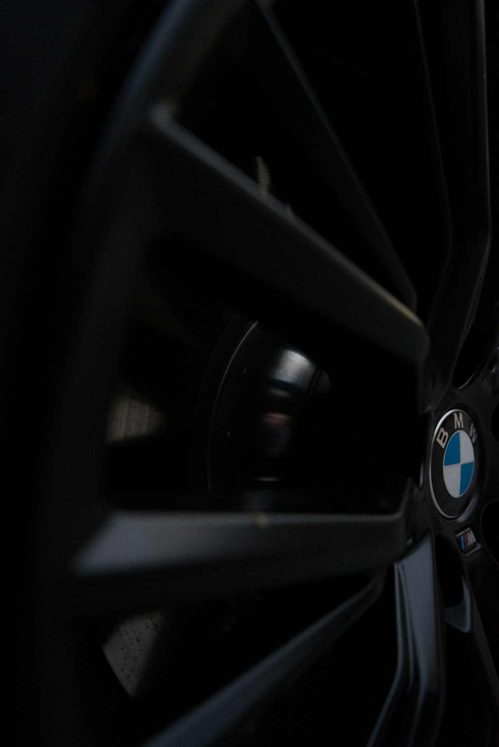 a close up of a bmw wheel with a black background