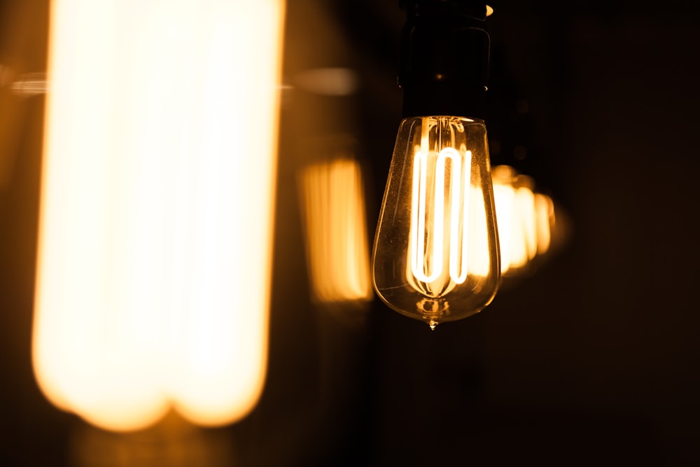 a light bulb hanging from a ceiling in a dark room