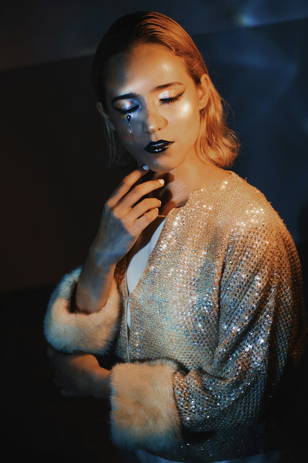 a woman with makeup on her face is posing for a photo