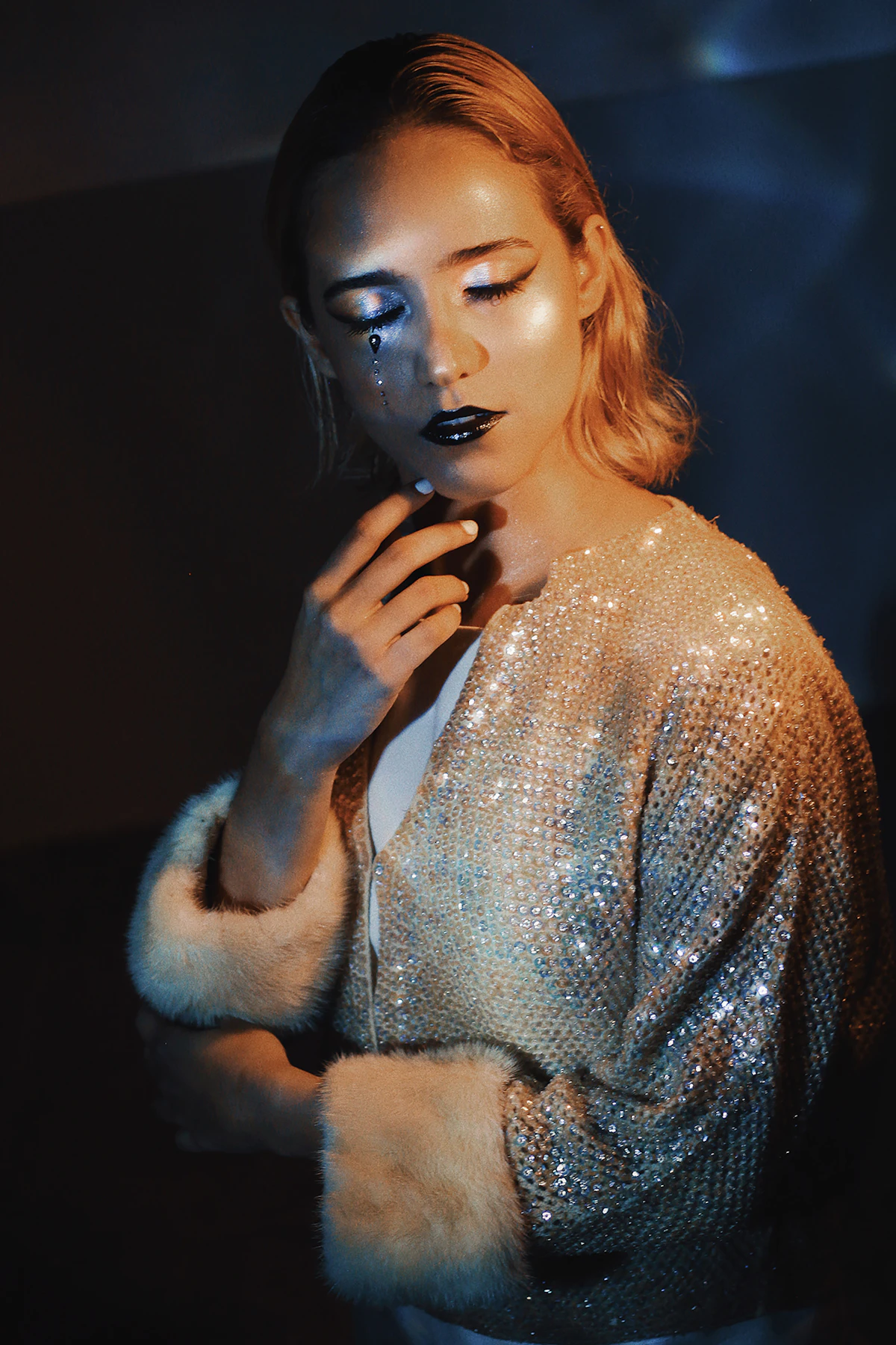 Editorial beauty portrait with dramatic makeup and contrast