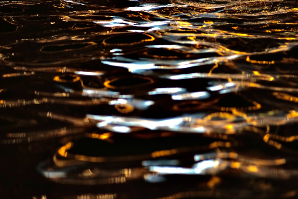 a blurry image of water with yellow and blue lights