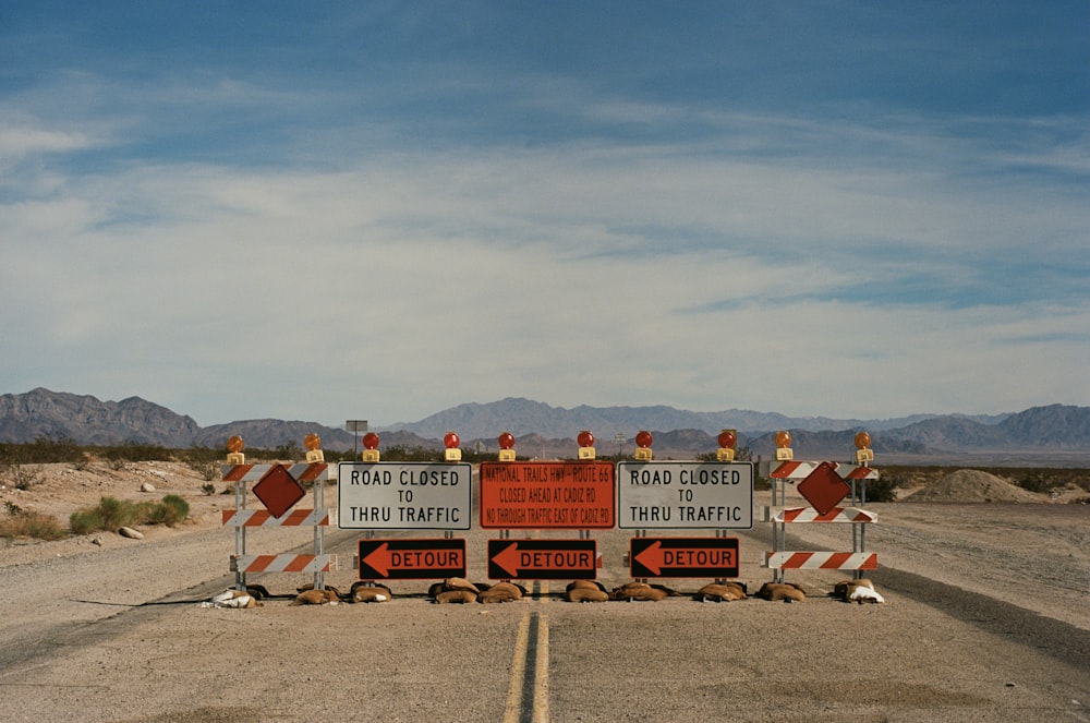 a couple of road signs sitting on the side of a road