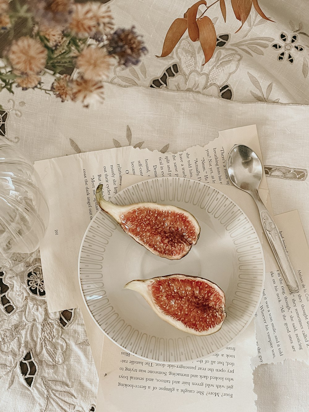 a white plate topped with two pieces of fruit