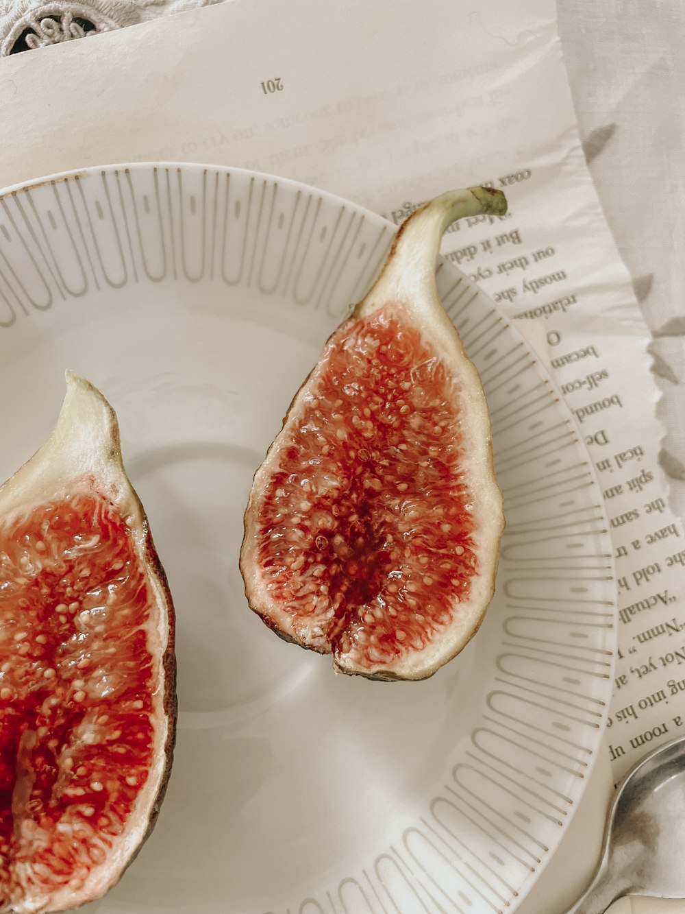 a white plate topped with two pieces of fruit