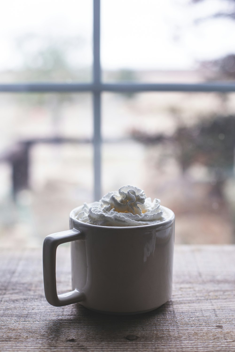 a cup of whipped cream sitting on a table