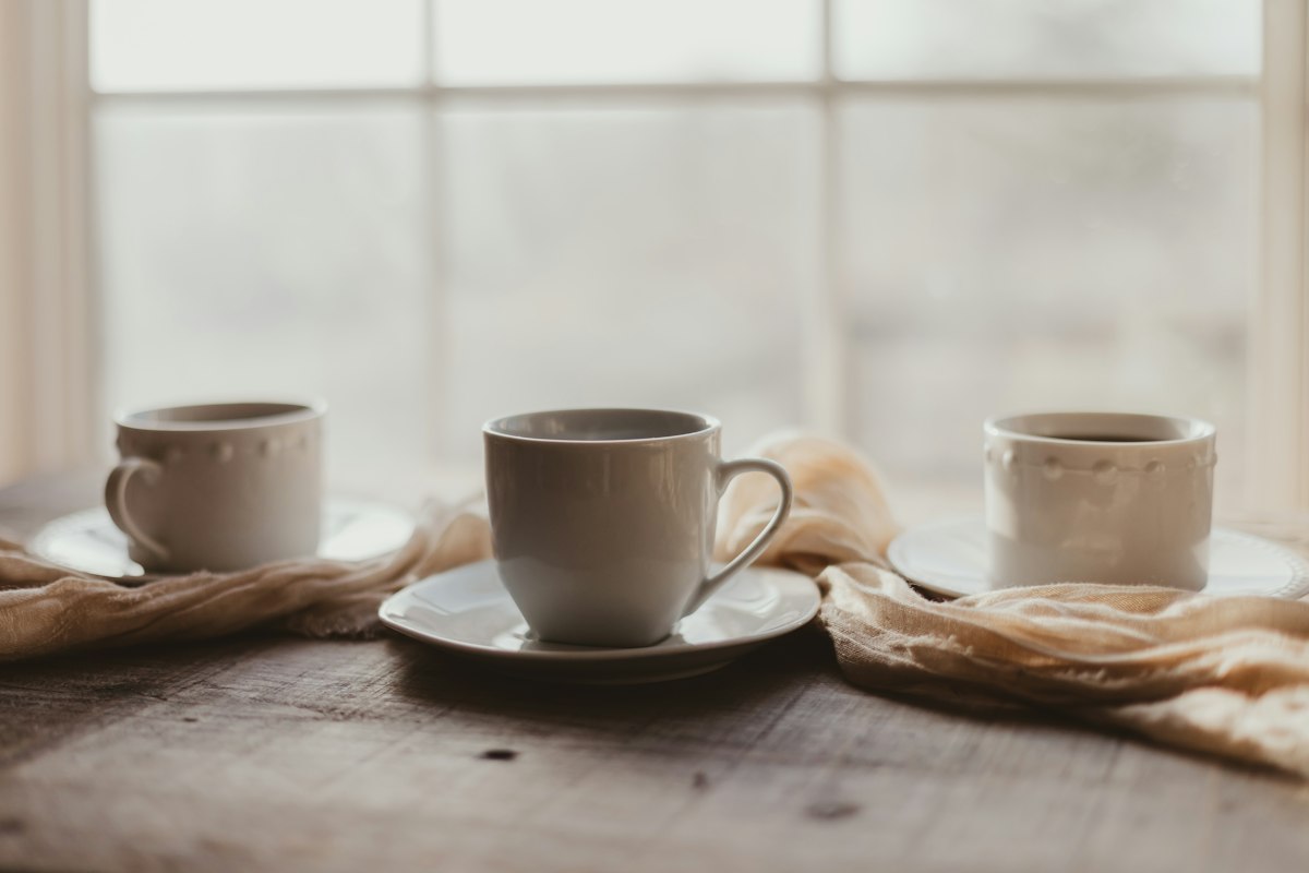 Two coffee cups on a wooden table