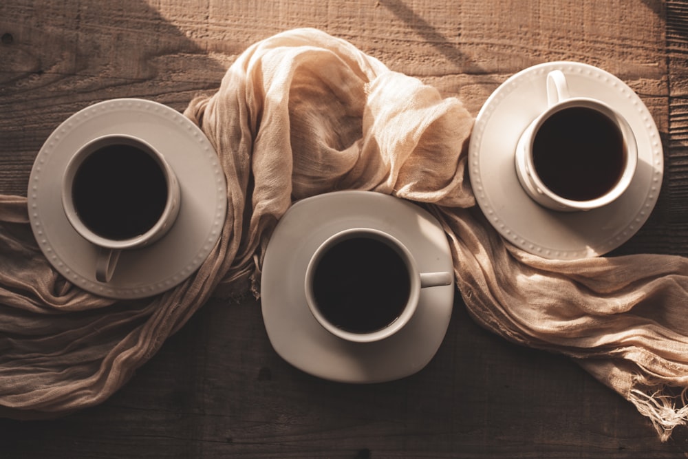 two cups of coffee are sitting on a table