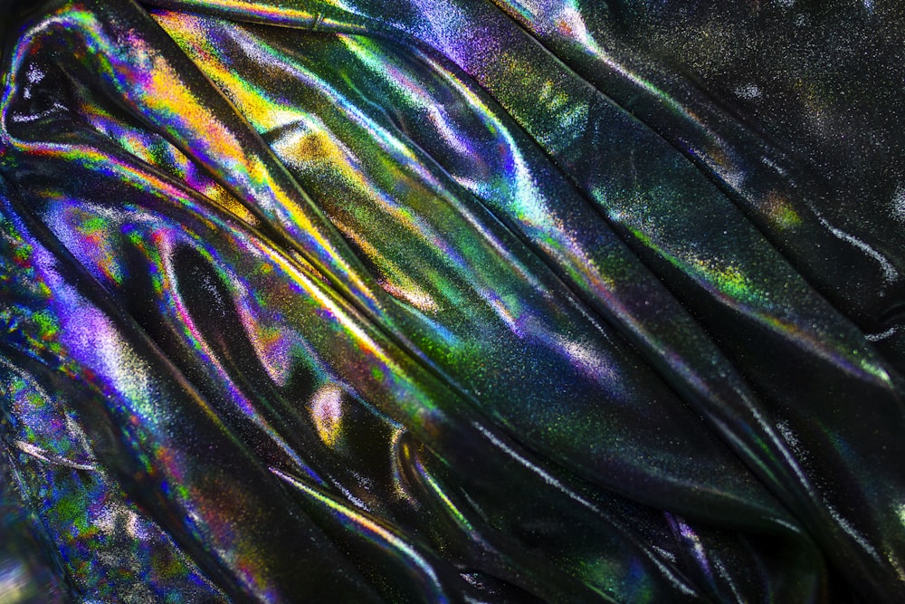a shiny metallic material with a black background