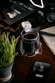 A creative workspace with notes, a smartphone, and a cup of coffee.