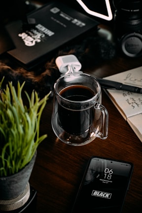 A creative workspace with notes, a smartphone, and a cup of coffee.