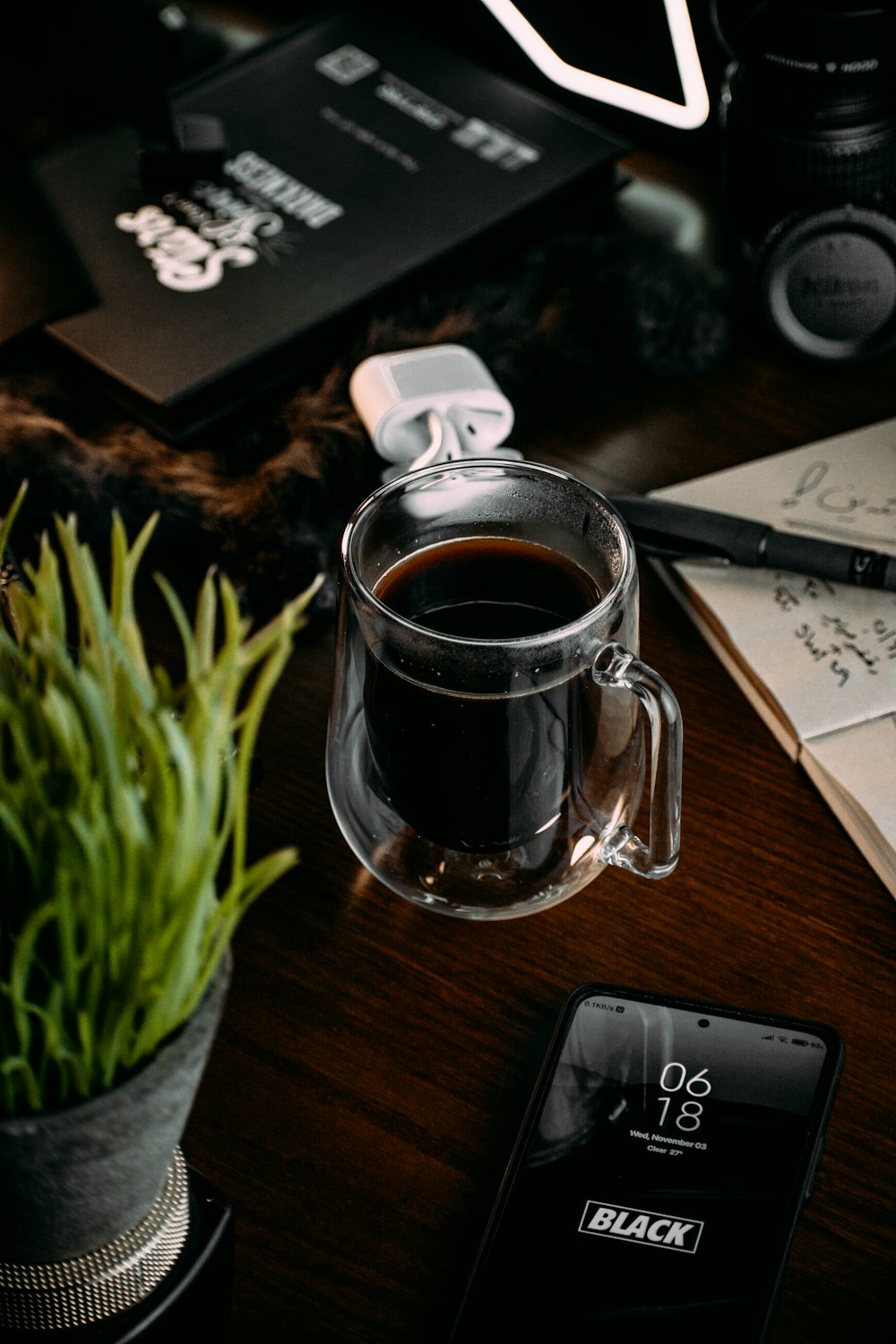 a cup of coffee sitting on top of a wooden table