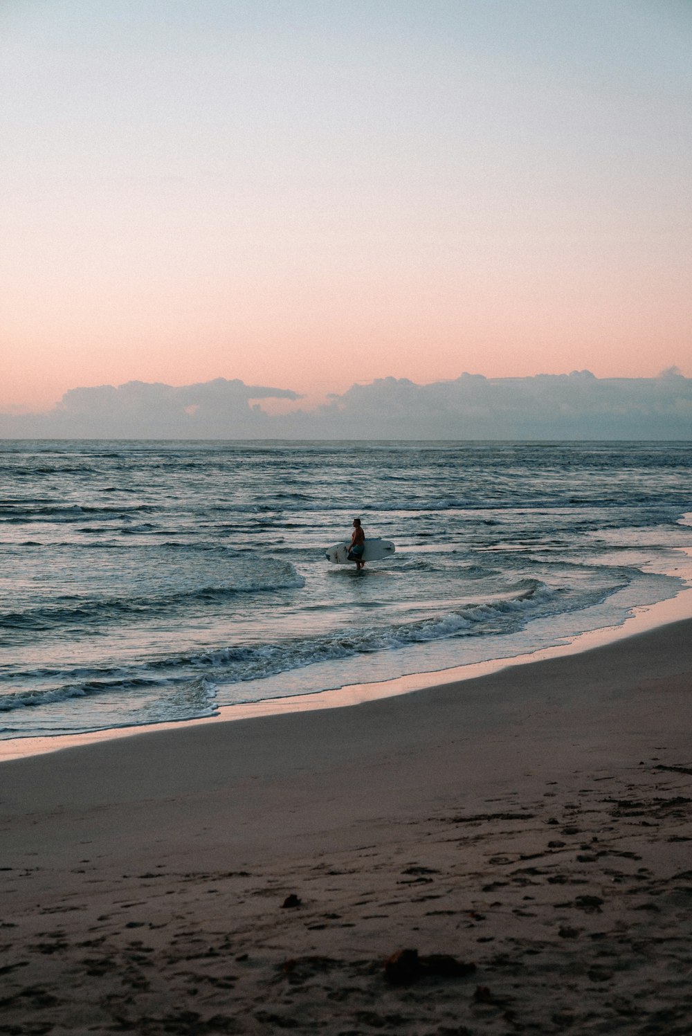 a person riding a surfboard on top of a wave