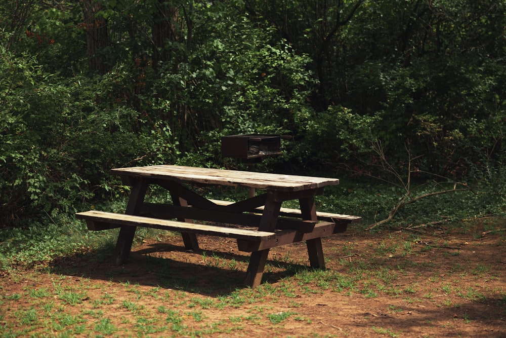 a picnic table sitting in the middle of a field