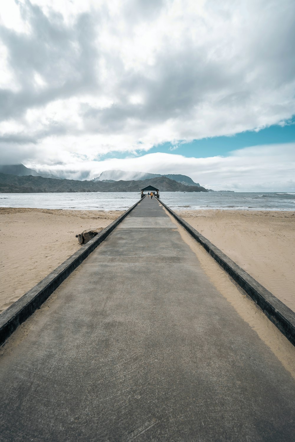 a long stretch of concrete on a beach