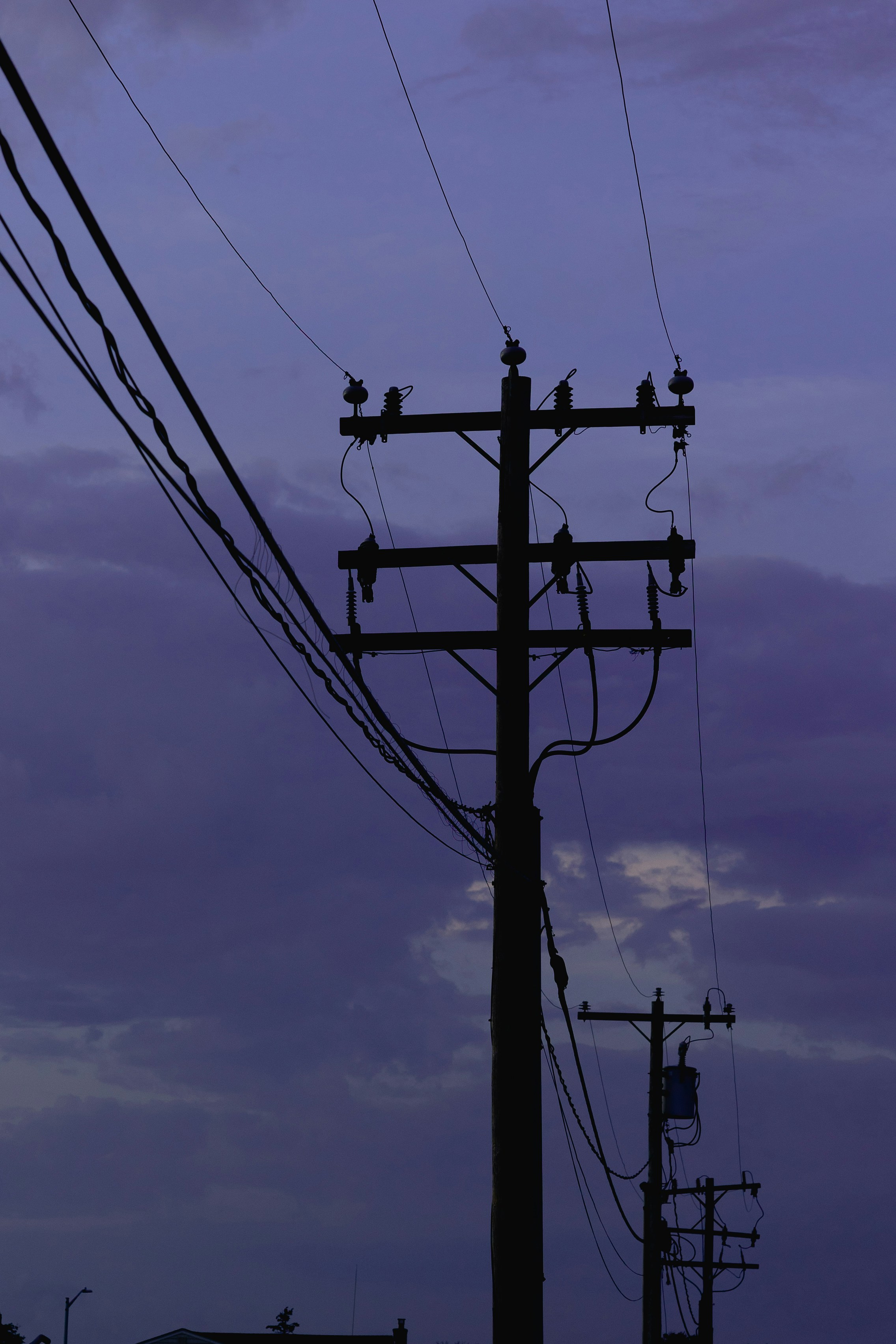 a telephone pole with a sky in the background