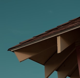 a close up of a roof with a blue sky in the background