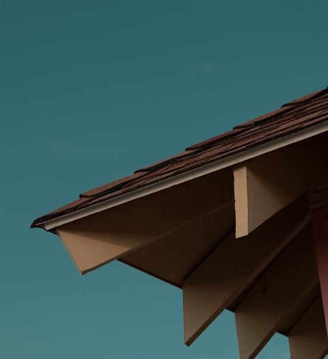 a close up of a roof with a blue sky in the background