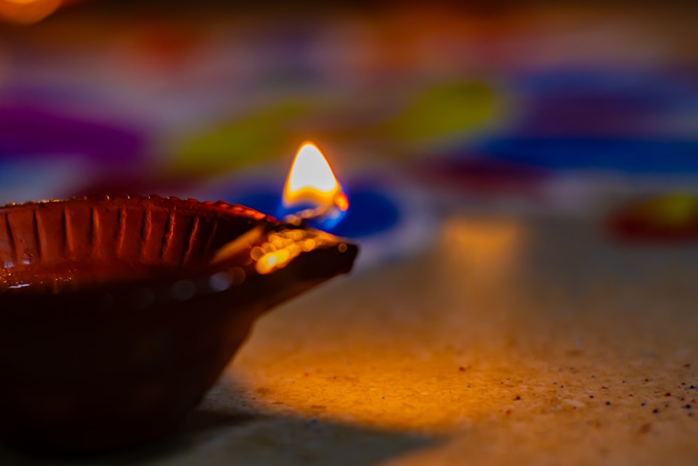 a lit candle sitting on top of a table